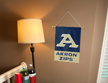 Load image into Gallery viewer, Blue &amp; Gold 13x18 inch long Akron University Garden Flag with Akron Zips Logo hanging on a Banner Pole Inside a well-lit room
