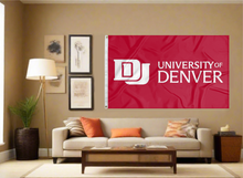 Load image into Gallery viewer, Red 3x5 foot wide University of Denver Flag with school logo and two metal grommets covering the tan wall of a living room
