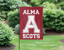 Load image into Gallery viewer, Maroon 13x18 inch long Alma College Garden Flag with Alma A College Scots Logo hanging on a black garden flag stand
