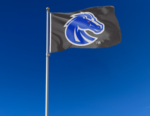 Black 3x5 foot wide Boise State University Flag with blue and gray Bronco head logo and two metal grommets attached to flagpole waving in the wind