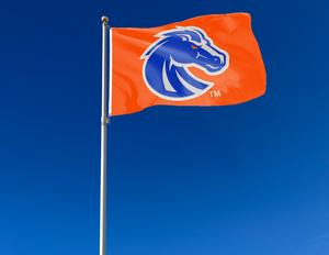 Orange 3x5 foot wide Boise State University Flag with blue and gray Bronco head logo and two metal grommets attached to flagpole waving in the wind